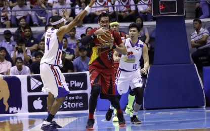 <p>San Miguel Beermen's Junemar Fajardo keeps the ball from opponents Ian Sangalang and Rafi Reavis of Magnolia Hotshots during the PBA Philippine Cup Finals Game 2 at the Smart Araneta Coliseum on Sunday night (April 1, 2018). <em>(Photo courtesy of PBA Media Bureau)</em></p>